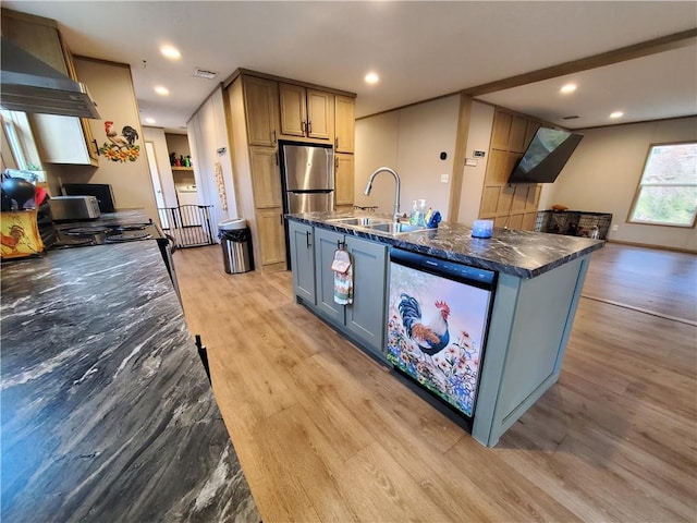 kitchen with a kitchen island with sink, sink, light hardwood / wood-style flooring, wall chimney exhaust hood, and stainless steel appliances