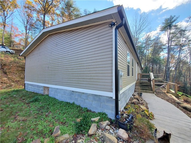 view of side of home featuring a wooden deck