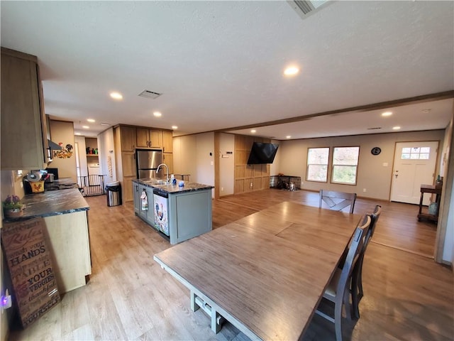 dining area with light hardwood / wood-style floors and sink