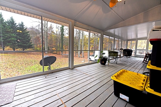 sunroom featuring ceiling fan, a healthy amount of sunlight, and lofted ceiling