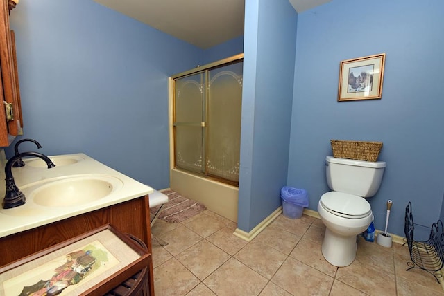 full bathroom featuring toilet, enclosed tub / shower combo, vanity, and tile patterned flooring