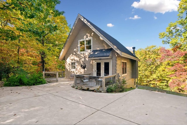 rear view of house featuring a deck