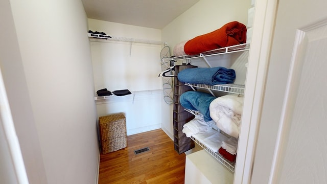 spacious closet with hardwood / wood-style floors