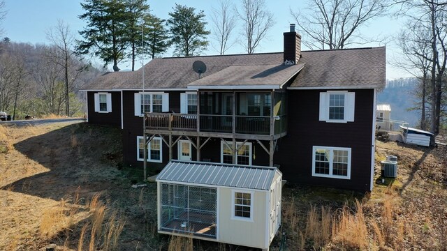 rear view of house with a balcony and central air condition unit