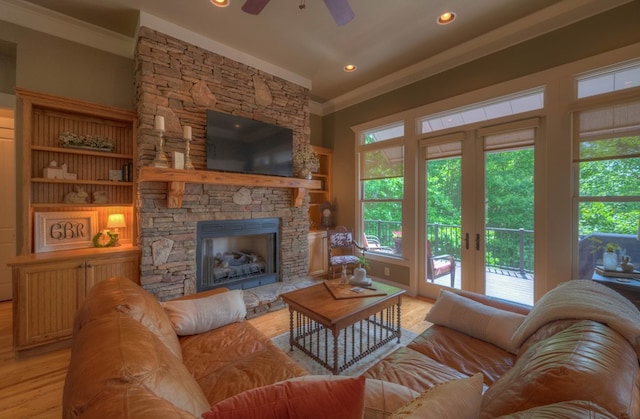 41 Elm Ct, Murphy, NC 28906 - living room featuring ornamental molding, light wood-style floors, ceiling fan, healthy amount of natural light, and a stone fireplace