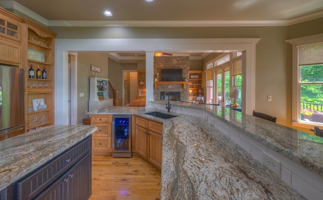 41 Elm Ct, Murphy, NC 28906 - kitchen with wine cooler, light wood-type flooring, a stone fireplace, ornamental molding, and recessed lighting