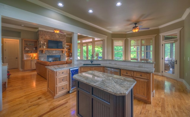 41 Elm Ct, Murphy, NC 28906 - kitchen with a spacious island, wine cooler, a ceiling fan, a fireplace, and ornamental molding