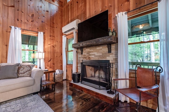 318 Buck Ridge Rd, Suches, GA 30572 - living area with a fireplace, an AC wall unit, wooden walls, and wood finished floors