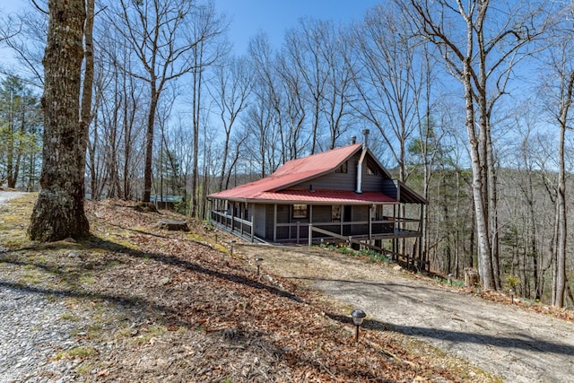 318 Buck Ridge Rd, Suches, GA 30572 - view of front of home with driveway, covered porch, a sunroom, a view of trees, and metal roof