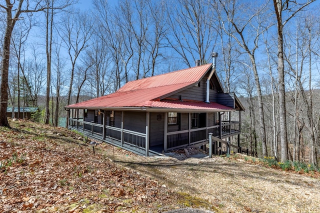 318 Buck Ridge Rd, Suches, GA 30572 - view of side of home with a wooded view, covered porch, and metal roof