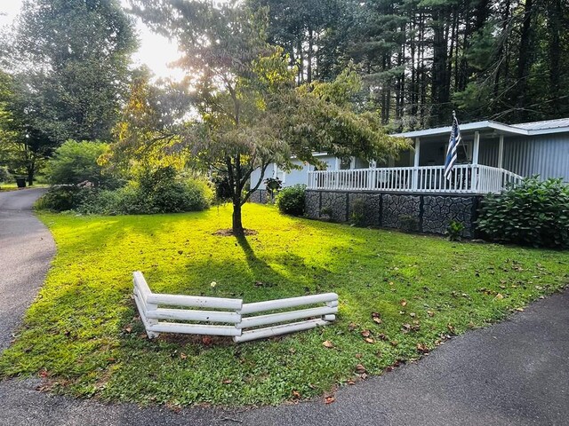 exterior space with a lawn and a porch