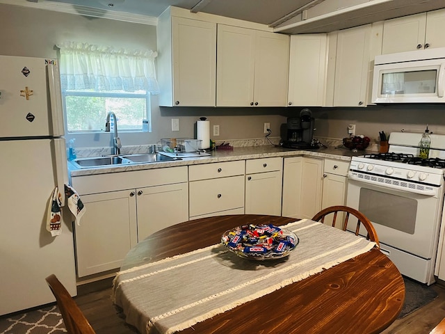 kitchen featuring sink, white appliances, dark hardwood / wood-style flooring, and white cabinets