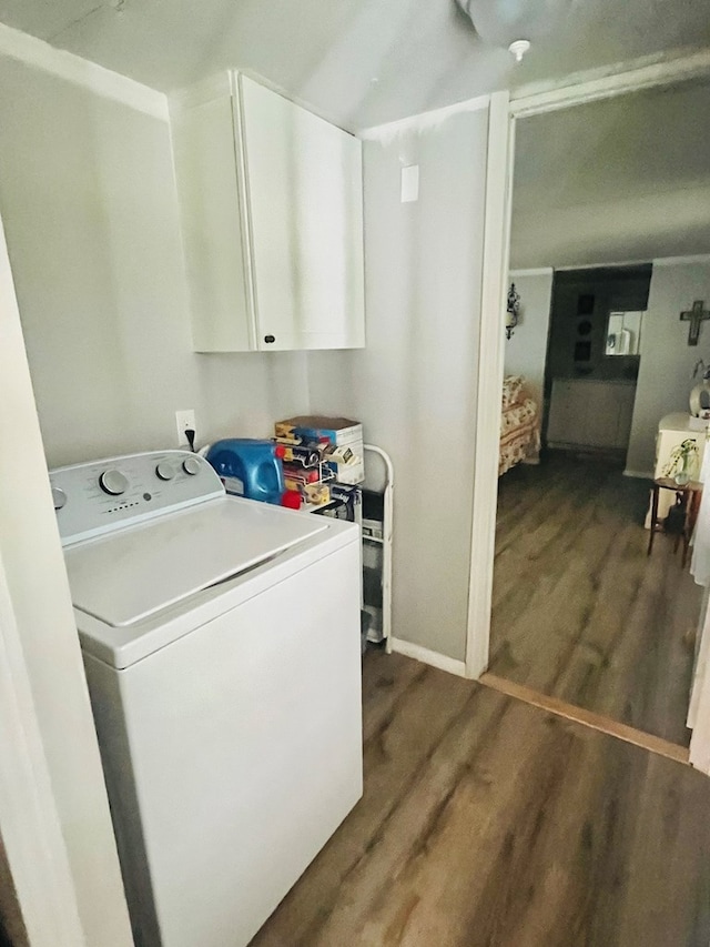 laundry room featuring washer / clothes dryer, cabinets, and dark hardwood / wood-style flooring