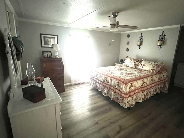 bedroom with hardwood / wood-style floors, ceiling fan, and crown molding