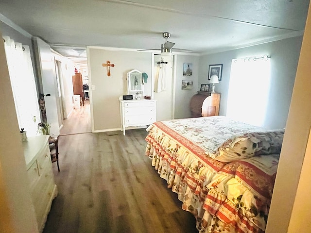 bedroom featuring ceiling fan, ornamental molding, and wood-type flooring