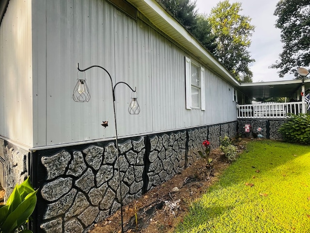 view of side of home with a lawn