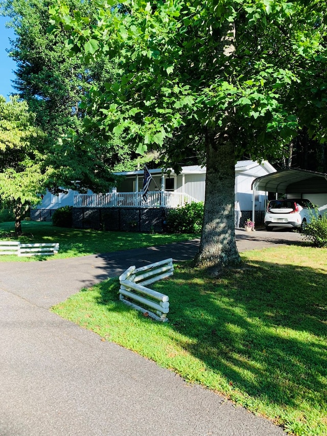 exterior space with a front lawn and a carport