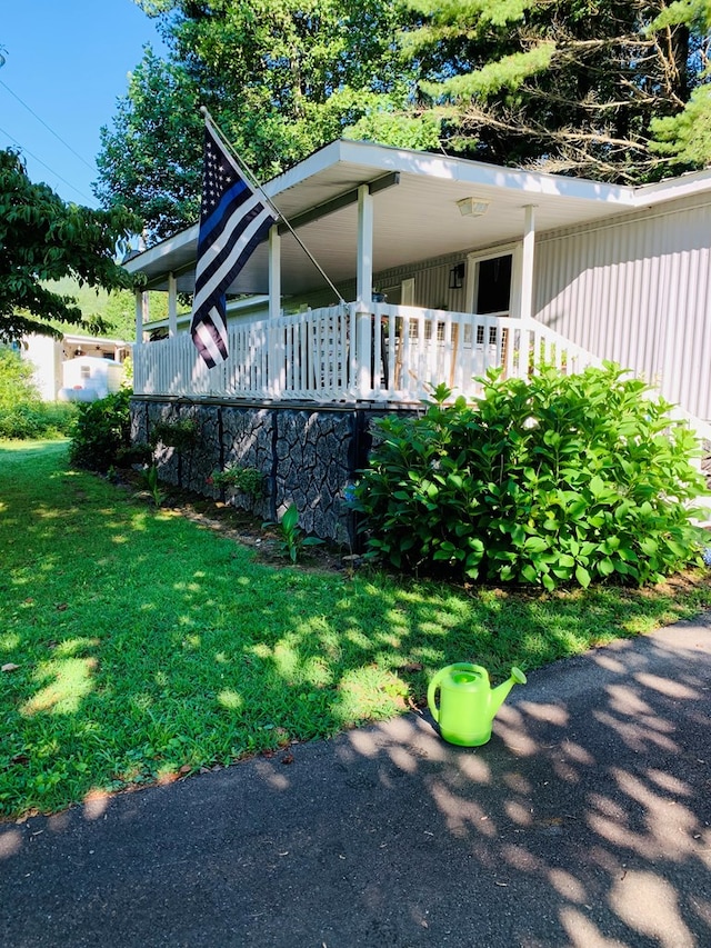 exterior space with a porch and a lawn