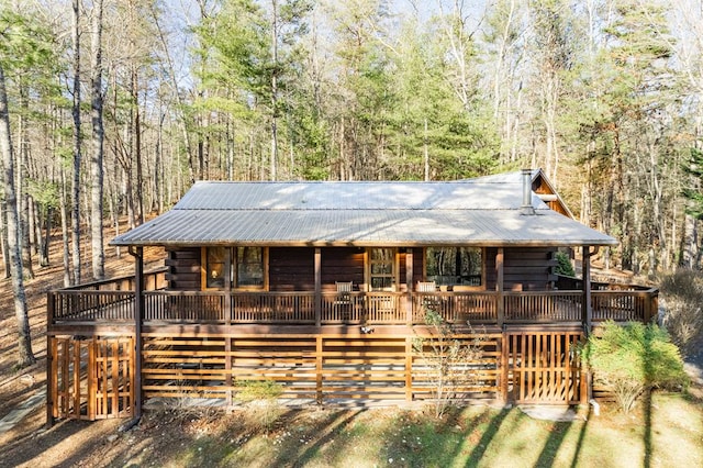 log home with a wooden deck