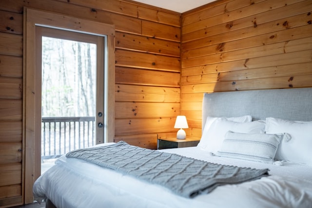 bedroom featuring wood walls