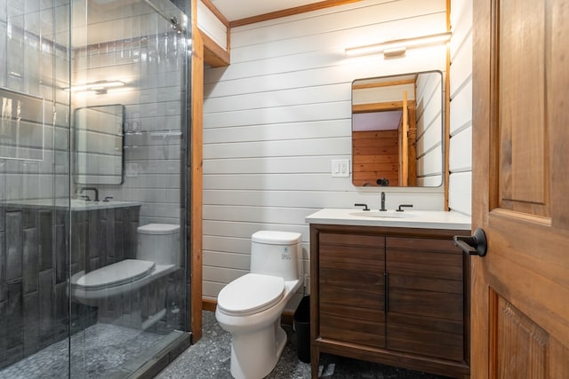 bathroom with toilet, vanity, wooden walls, and a shower with door