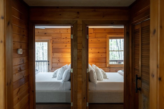 bedroom with wood walls and hardwood / wood-style flooring