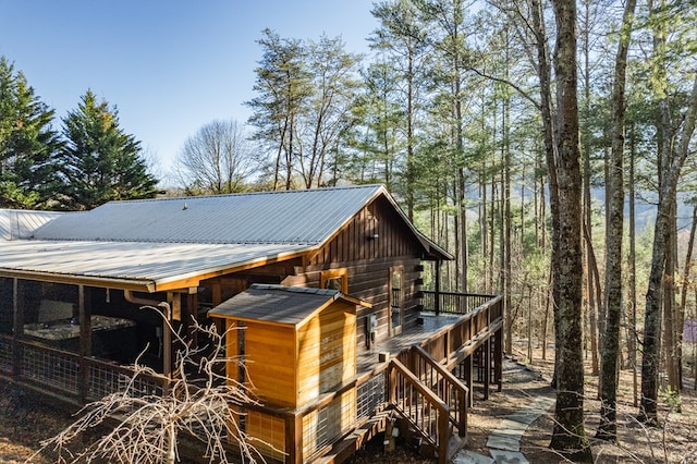 view of side of home with a wooden deck