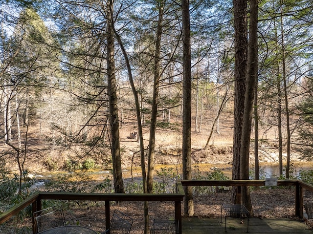 view of yard featuring a deck with water view