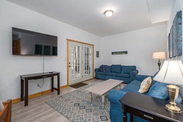 living room featuring french doors and light hardwood / wood-style flooring