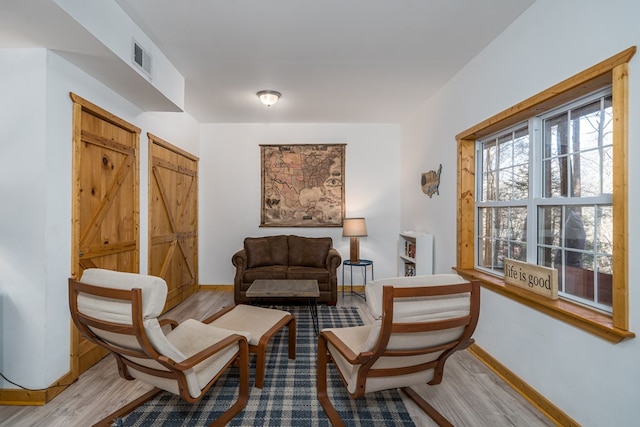 sitting room with light hardwood / wood-style flooring