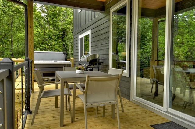 wooden terrace with area for grilling and outdoor dining space