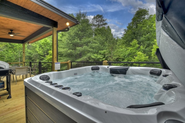 wooden deck featuring a hot tub