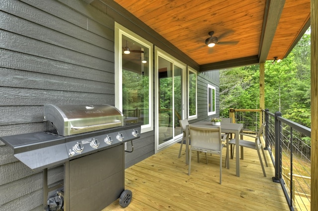 deck with ceiling fan, outdoor dining area, and grilling area