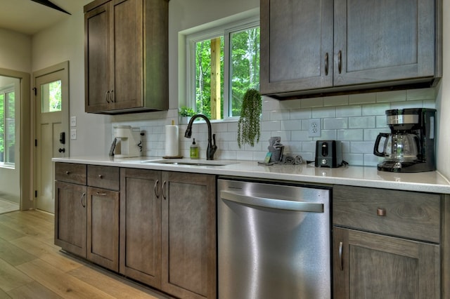 kitchen with dishwasher, plenty of natural light, light wood-type flooring, and a sink