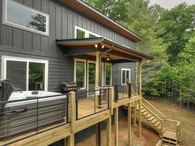 wooden deck with stairs, grilling area, and a hot tub