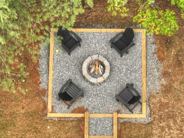 exterior details with a fire pit and a flat roof