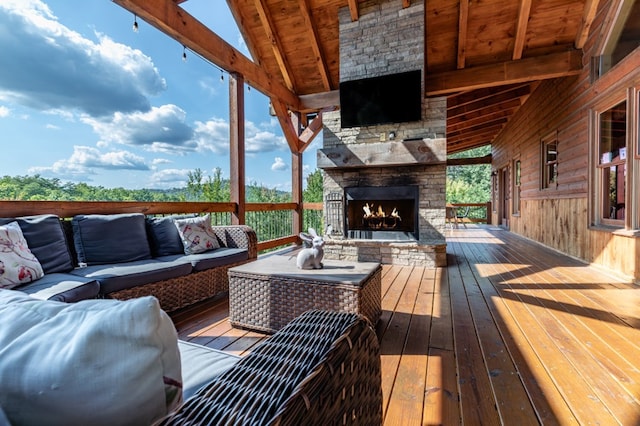 wooden deck with an outdoor living space with a fireplace