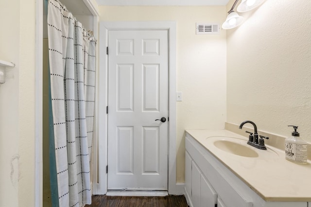 bathroom featuring vanity and wood-type flooring