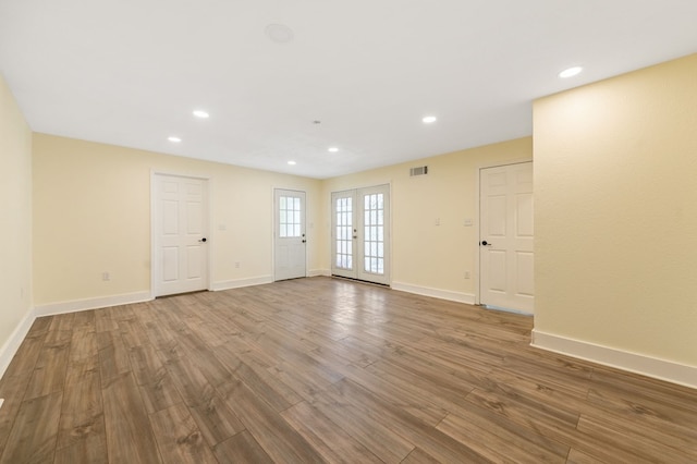 empty room with french doors and wood-type flooring