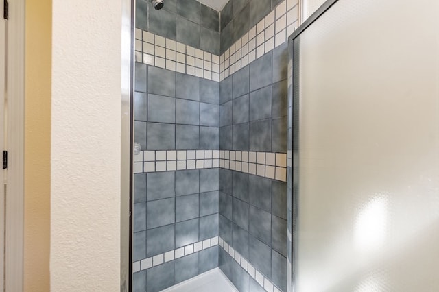 bathroom with a tile shower