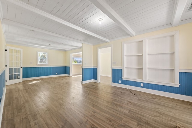 unfurnished living room featuring beamed ceiling, wood ceiling, and hardwood / wood-style flooring