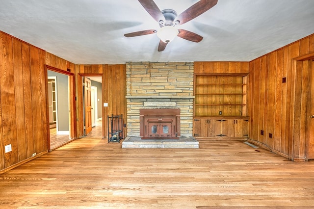 241 Boulevard St, Murphy, NC 28906 - unfurnished living room with wood walls, built in features, ceiling fan, wood finished floors, and baseboards