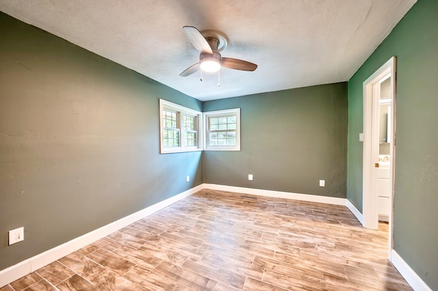 241 Boulevard St, Murphy, NC 28906 - empty room with ceiling fan, a textured ceiling, light wood-style flooring, and baseboards