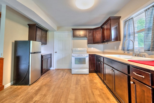 241 Boulevard St, Murphy, NC 28906 - kitchen with freestanding refrigerator, electric stove, a sink, and light countertops