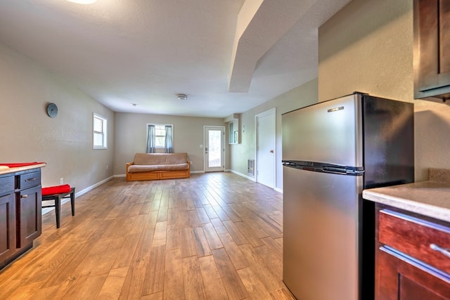241 Boulevard St, Murphy, NC 28906 - kitchen with freestanding refrigerator, light countertops, light wood-type flooring, and open floor plan