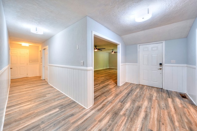 241 Boulevard St, Murphy, NC 28906 - foyer featuring a textured ceiling, wood finished floors, wainscoting, lofted ceiling, and ceiling fan
