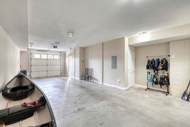 garage featuring electric panel and baseboards