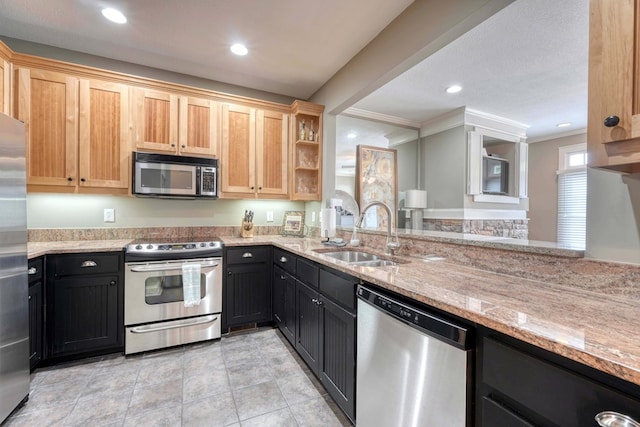 kitchen featuring a sink, light stone counters, recessed lighting, stainless steel appliances, and crown molding