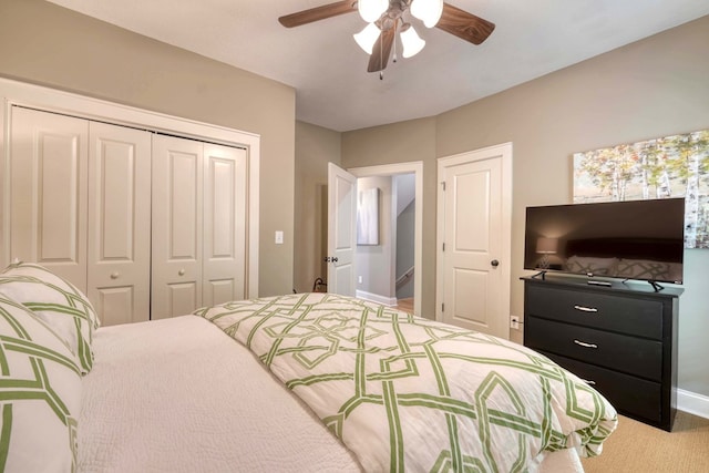 bedroom featuring a closet, baseboards, ceiling fan, and carpet floors