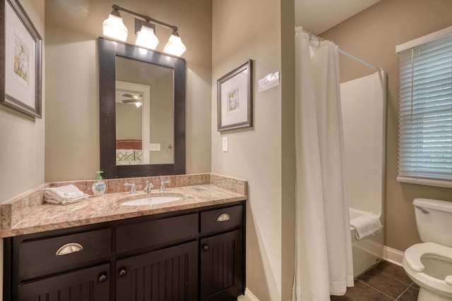 full bathroom featuring tile patterned flooring, toilet, vanity, and baseboards